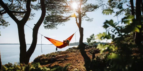 Woman in hammock by the ocean